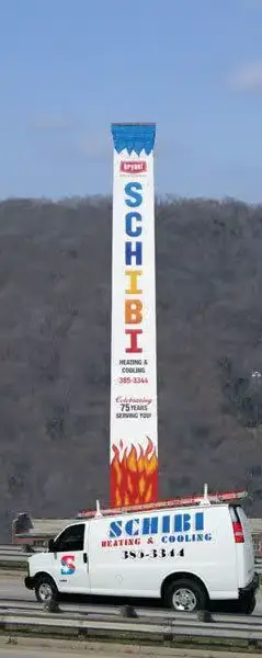 Schibi Heating and Cooling branded tower sign with company service van